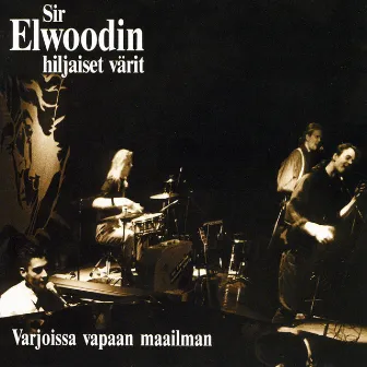 Varjoissa Vapaan Maailman 10v. Juhlapainos by Sir Elwoodin hiljaiset värit